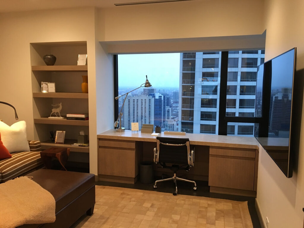 A room with a large window and a desk