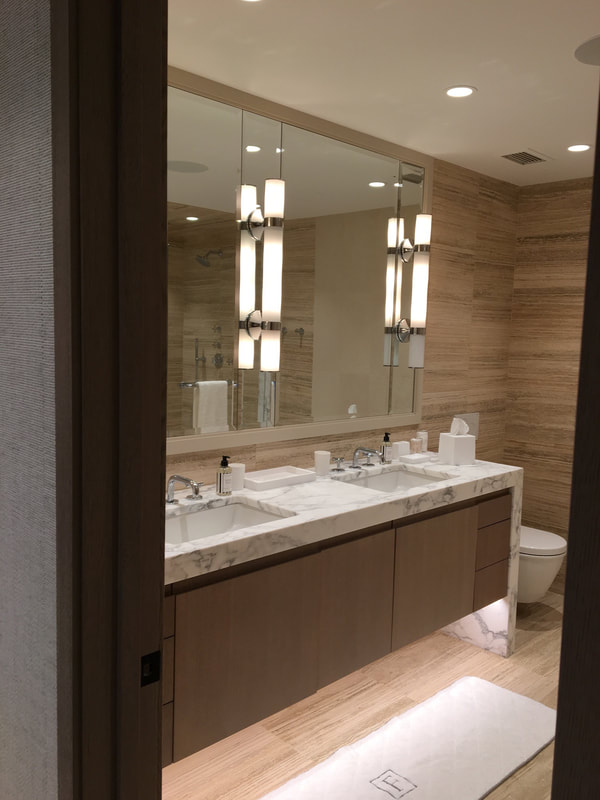A bathroom with two sinks and a large mirror.