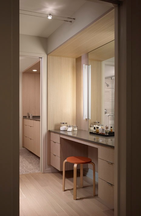 A bathroom with a vanity and mirror in it