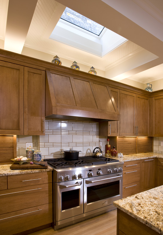 A kitchen with wooden cabinets and granite countertops.