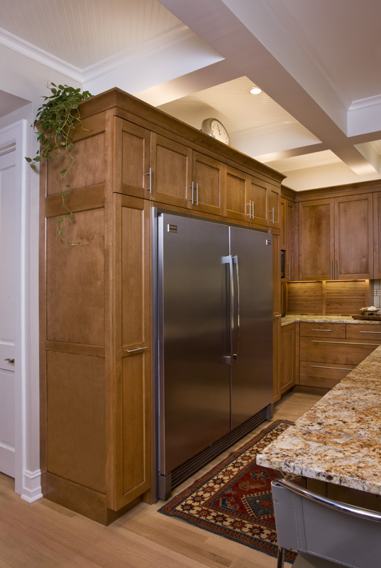 A large stainless steel refrigerator in the middle of a kitchen.
