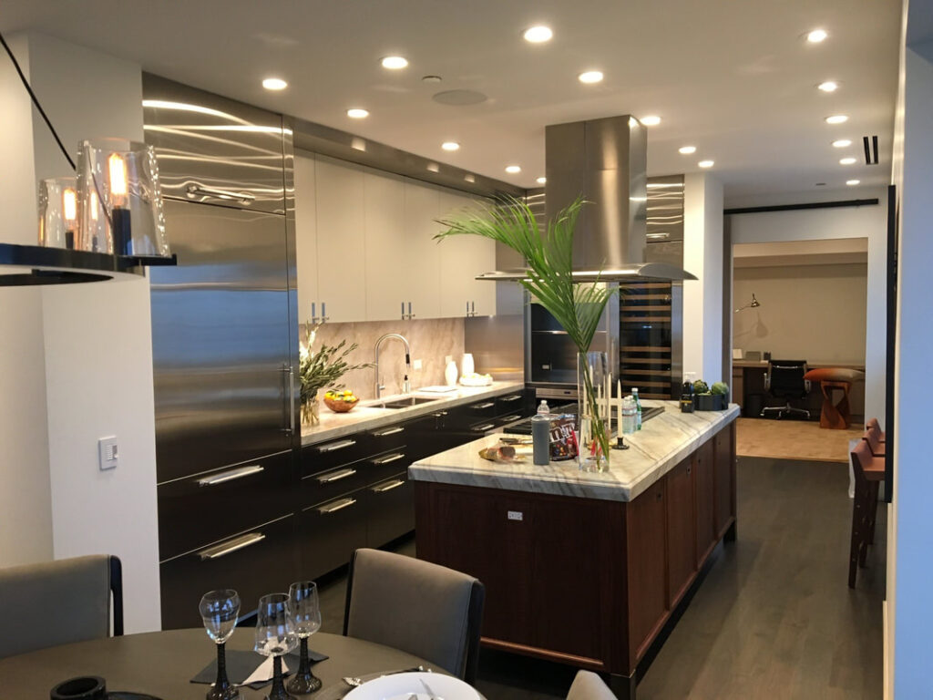 A kitchen with stainless steel appliances and wooden cabinets.
