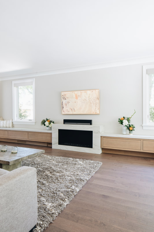A living room with a fireplace and a flat screen tv.