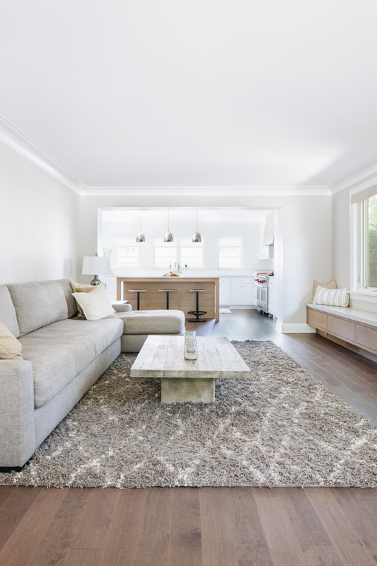 A living room with white walls and furniture.