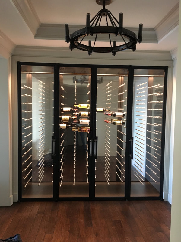 A wine cellar with multiple glass doors and shelves.